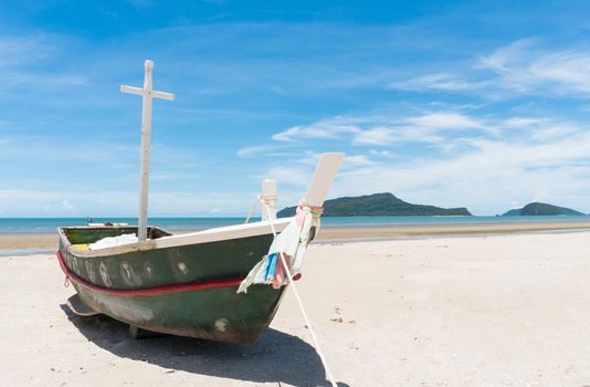 Fishing boat or fisherman boat or ship on Sam Roi Yod bech Prachuap Khiri Khan Thailand with blue sky and cloud and blue sea and mountain or hill. Landscape or scenery for summer season concept