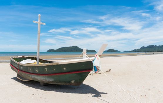 Fishing boat or fisherman boat or ship on Sam Roi Yod bech Prachuap Khiri Khan Thailand with blue sky and cloud and blue sea and mountain or hill. Landscape or scenery for summer season concept