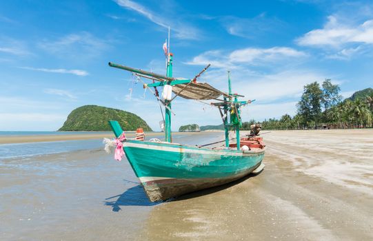 Green Fishing Boat or Fisherman Boat or Ship and blue sky and mountain or hill at Sam Roi Yod Beach Prachuap Khiri Khan Thailand. Landscape 
or scenery for summer season concept