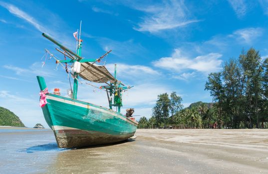 Green Fishing Boat or Fisherman Boat or Ship and blue sky and mountain or hill at Sam Roi Yod Beach Prachuap Khiri Khan Thailand. Landscape 
or scenery for summer season concept