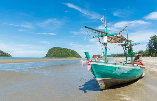Green Fishing Boat or Fisherman Boat or Ship and blue sky and mountain or hill at Sam Roi Yod Beach Prachuap Khiri Khan Thailand. Landscape 
or scenery for summer season concept