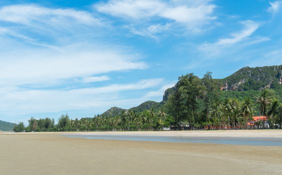 Green Rock or Stone Mountain or Hill and Coconut Tree at Sam Roi Yod Beach Prachuap Khiri Khan Thailand. Landscape or scenery for summer 
season concept