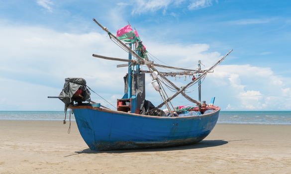 Blue fishing boat or fisherman boat or ship on Sam Roi Yod bech Prachuap Khiri Khan Thailand with blue sky and cloud and blue sea. Landscape or scenery for summer season concept