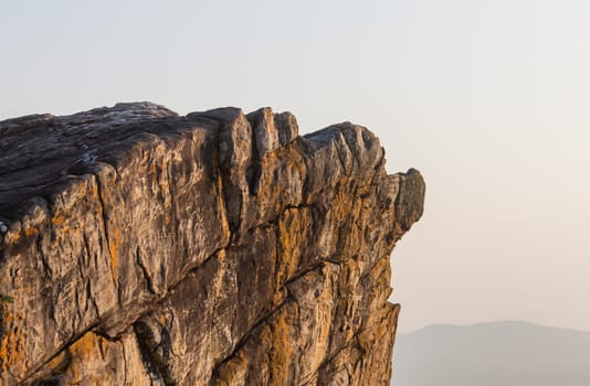 Pha Hua Rue Rock Cliff Mountain Hill Phayao Attractions Thailand with Warm Sun Light and Green Tree Landscape Left Close up. Natural stone or rock mountain hill at Phayao northern Thailand travel