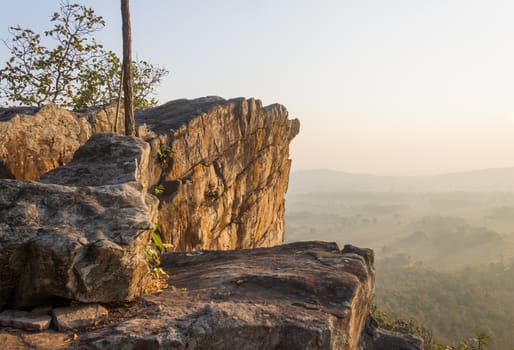 Pha Hua Rue Rock Cliff Mountain Hill Phayao Attractions Thailand with Warm Sun Light and Green Tree Landscape Left. Natural stone or rock mountain hill at Phayao northern Thailand travel