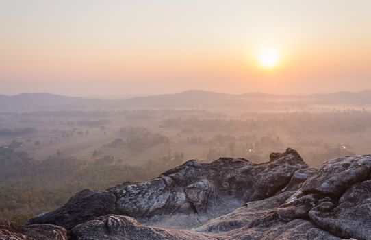 Right Sunrise at Pha Hua Rue Phayao Attractions Thailand Travel. Natural stone or rock mountain with sunrise sky and mist at Phayao northern Thailand travel