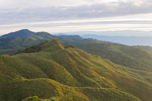 Landscape Phu Langka Mountain National Park at Phayao Thailand travel Left Frame. Green tree mountain and cloud sky and warm sun light at Phu Langka national park view point Phayao Thailand. Northern Thailand travel