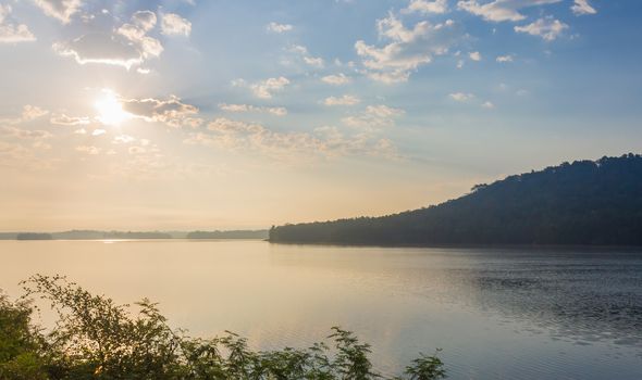 Landscape Mountain with Blue Sky Sunshine Cloud Water Fog and Tree Background. Good Weather in winter with mountain landscape blue sky sunshine cloud water fog and tree