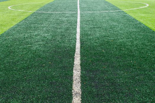 White center line of soccer field. Center line on artificial grass football field