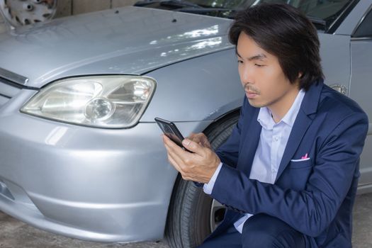 Asian Insurance Agent or Insurance Agency in Suit See Smartphone and Inspecting Car Crash from Accident for Claim at Outdoor Place on Wide Angle View