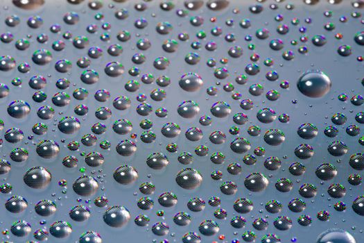 many small water drops on the surface of cellphone hydriphobic coated glass screen, close-up with selective focus and visible subpixel rgb triads