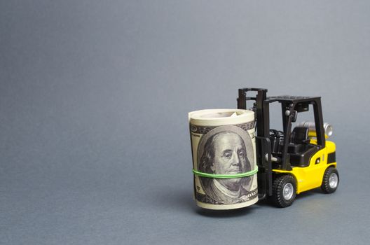Forklift truck carries a bundle of dollars. Attracting direct investment in business and production, improving economic performance. Export of capital, offshore economic zones. Capital and capitalism.