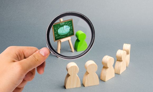 Magnifying glass is looking at a person holds a presentation to a crowd of people at a briefing, development of the company. discussion of the business strategy. Analysis results. Selective focus
