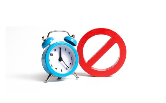 No sign and blue clock on an isolated background. Unavailability at certain hours. Temporary restrictions and prohibitions. Restrictions and sanctions, strict control. Stop annual watch transfers.