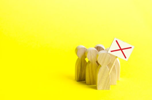 A group of protesting figures with signs on an yellow background. An angry mob of wooden figures of people with a poster. Social discontent and social tension, protest and disagreement.