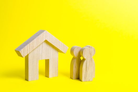 Figures of the family and house on a yellow background. real estate, your own home. Buying or selling. Affordable housing on credit or mortgage. Renovation and construction. Subsidies, citizenship.