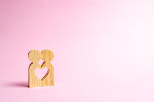 Figures of people stand together and form a heart-shaped void. Concept of love and relationships. Search for a partner and dating. Flirting, swingers. The second half on Valentine's Day.
