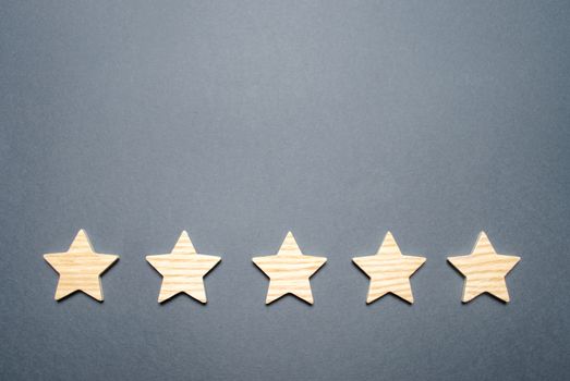 Five stars on a gray background. Rating and status of the restaurant or hotel. Prestige and a good title. High quality and reliability, universal acceptance. Pretentiousness, confidence and good name.