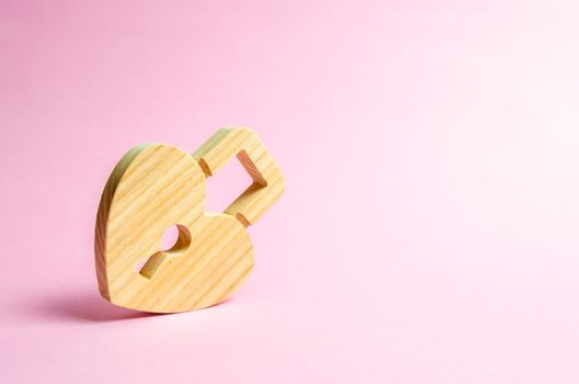 Padlock in the shape of a heart on a pink background. The secret of relationships and pickup rules. Strong love affair. Secrets, rumors and gossip. The concept of female intimate health