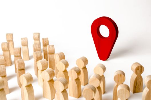 People are standing near the location marker. Concept of navigation and venue. Tourism and travel. Spying on the citizens.. Orientation around the city, the location of events and events.