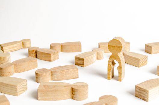A wooden figure of a man with an empty child-shaped inside the body is standing among other people. The concept of missing a child searching for a baby. Childlessness, sterility in women