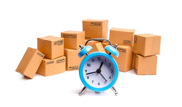 Cardboard boxes and clock on white background. Time of delivery. concept of buying and selling goods and services, internet commerce, online shopping, trade and turnover. Import and export