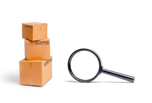 Cardboard boxes and a glass on a white background. The concept of packing goods, sending orders to customers. Warehouse of finished products and equipment. Moving to another house.
