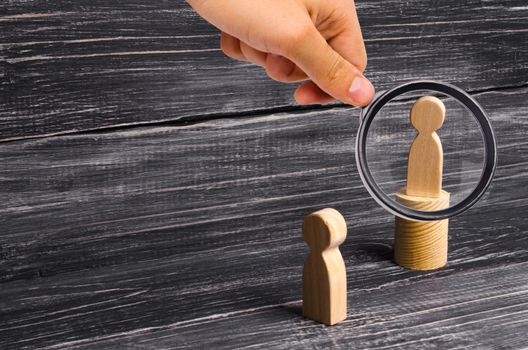 Magnifying glass is looking at the men stands on the podium and broadcasts his thoughts and ideas to listeners. The person gives orders, the leader, the boss. Pride, boastfulness.