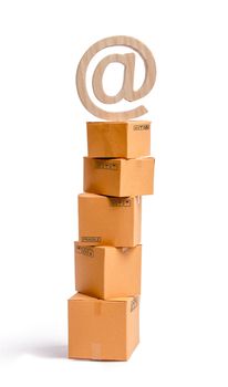 A tower of cardboard boxes and an email symbol on top. The concept of online sales, shopping and online shopping. Realization of goods and services through the Internet. buying and selling goods