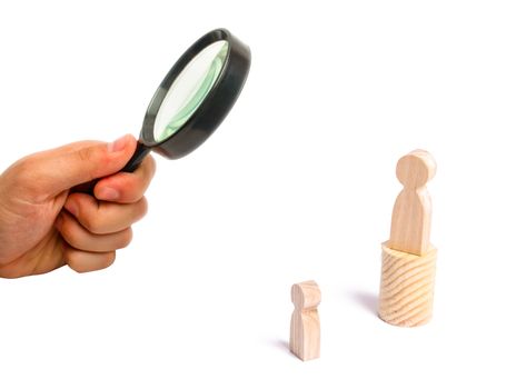 Magnifying glass is looking at the men stands on the podium and broadcasts his thoughts and ideas to listeners. The person gives orders, the leader, the boss.