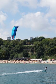 Varna, Bulgaria - July, 19, 2020: a man is kiting the sea against the background of the beachVarna