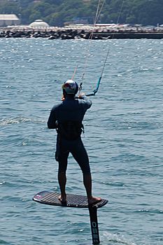 Varna, Bulgaria - July, 19, 2020: a man is kiting the sea against the background of the beachVarna