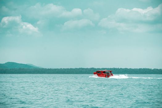 red speed boat driving on ocean for sent passenger to pier