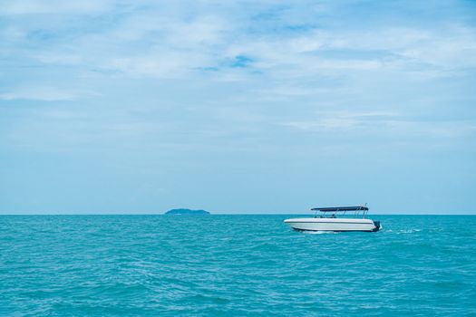 speed boat driving on ocean with cloudy sky