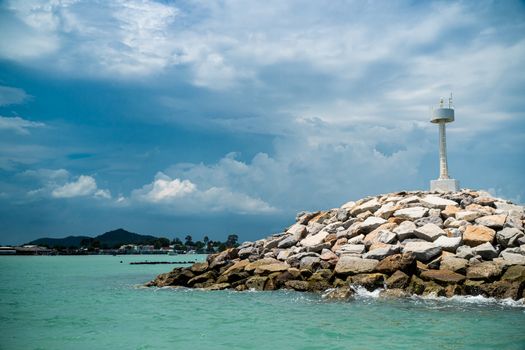 The breakwater line is constructed from rock in the sea.