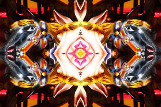 Abstract kaleidoscope mirror reflection of carousel horses texture background pattern stock photo