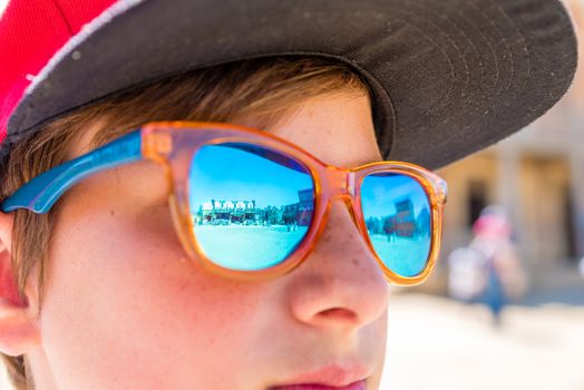 boy with sunglasses watching cowboy show