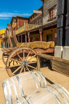 old horse carriage with straw and two wooden barrels