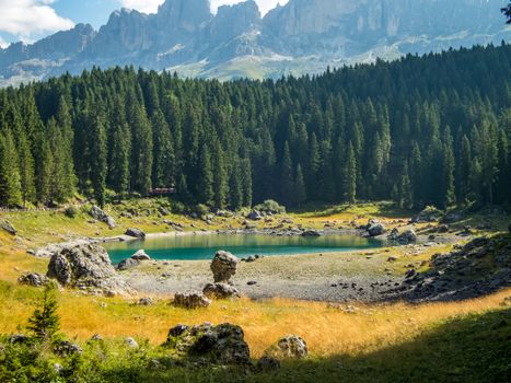 The Karersee below the Karerpass at the foot of the Latemar massif in South Tyrol, Italy
