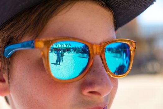 boy with sunglasses watching cowboy show
