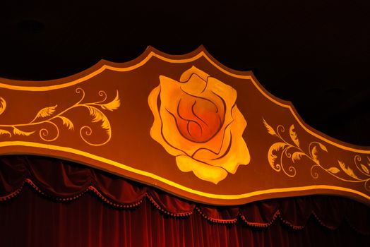 Stage with red curtains and a yellow rose. stage for shows