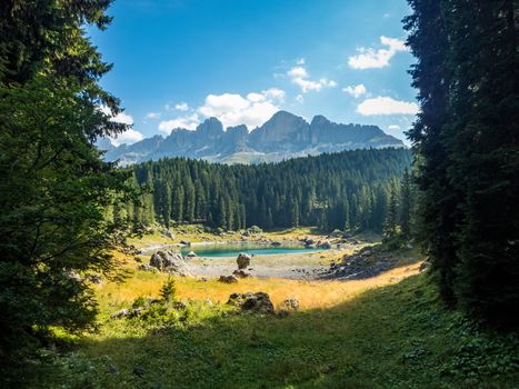 The Karersee below the Karerpass at the foot of the Latemar massif in South Tyrol, Italy