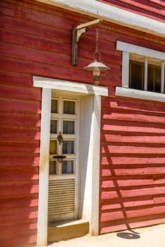 white vintage wooden door with red wall