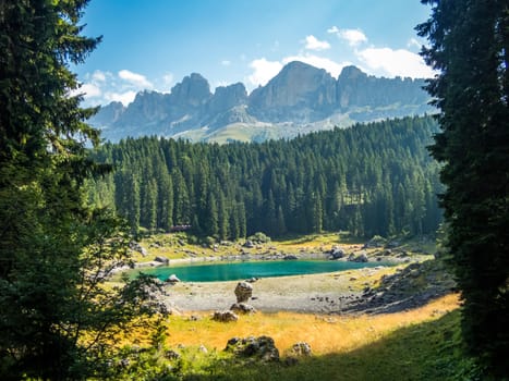 The Karersee below the Karerpass at the foot of the Latemar massif in South Tyrol, Italy