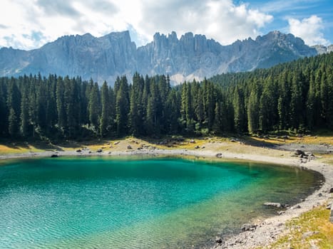 The Karersee below the Karerpass at the foot of the Latemar massif in South Tyrol, Italy