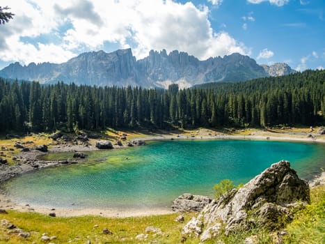 The Karersee below the Karerpass at the foot of the Latemar massif in South Tyrol, Italy