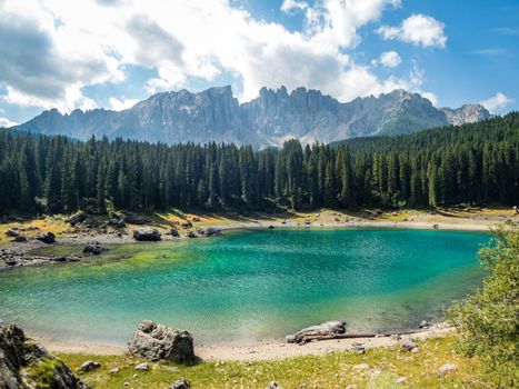 The Karersee below the Karerpass at the foot of the Latemar massif in South Tyrol, Italy