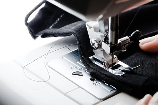Stitching of a face covering seam. Homemade using a sewing machine from all black chiffon and nylon.