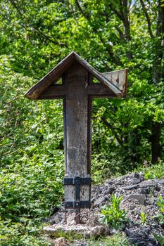 wooden large church cross in wooded terrain