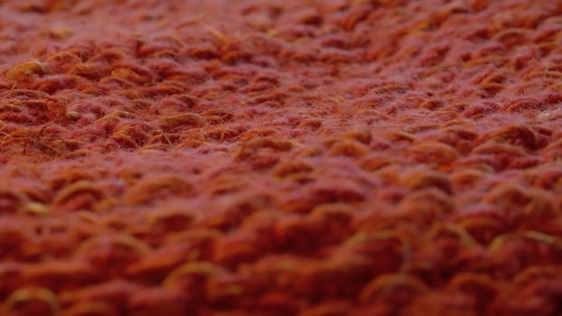 Macro shot of red knitted hemp fabric. Textile background, texture
